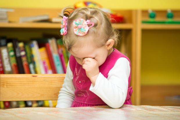Little child girl playing in kindergarten in Montessori preschool Class.