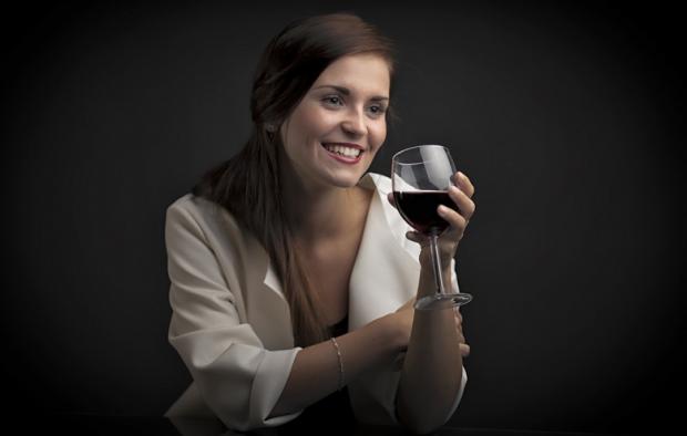Glamour portrait of a woman with glass of red wine