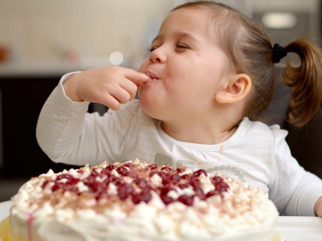 милая маленькая девочка ест торт